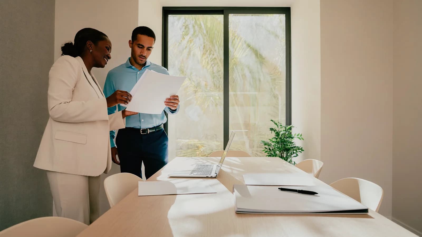Business owners reviewing papers for a certificate of existence translation in a Miami office