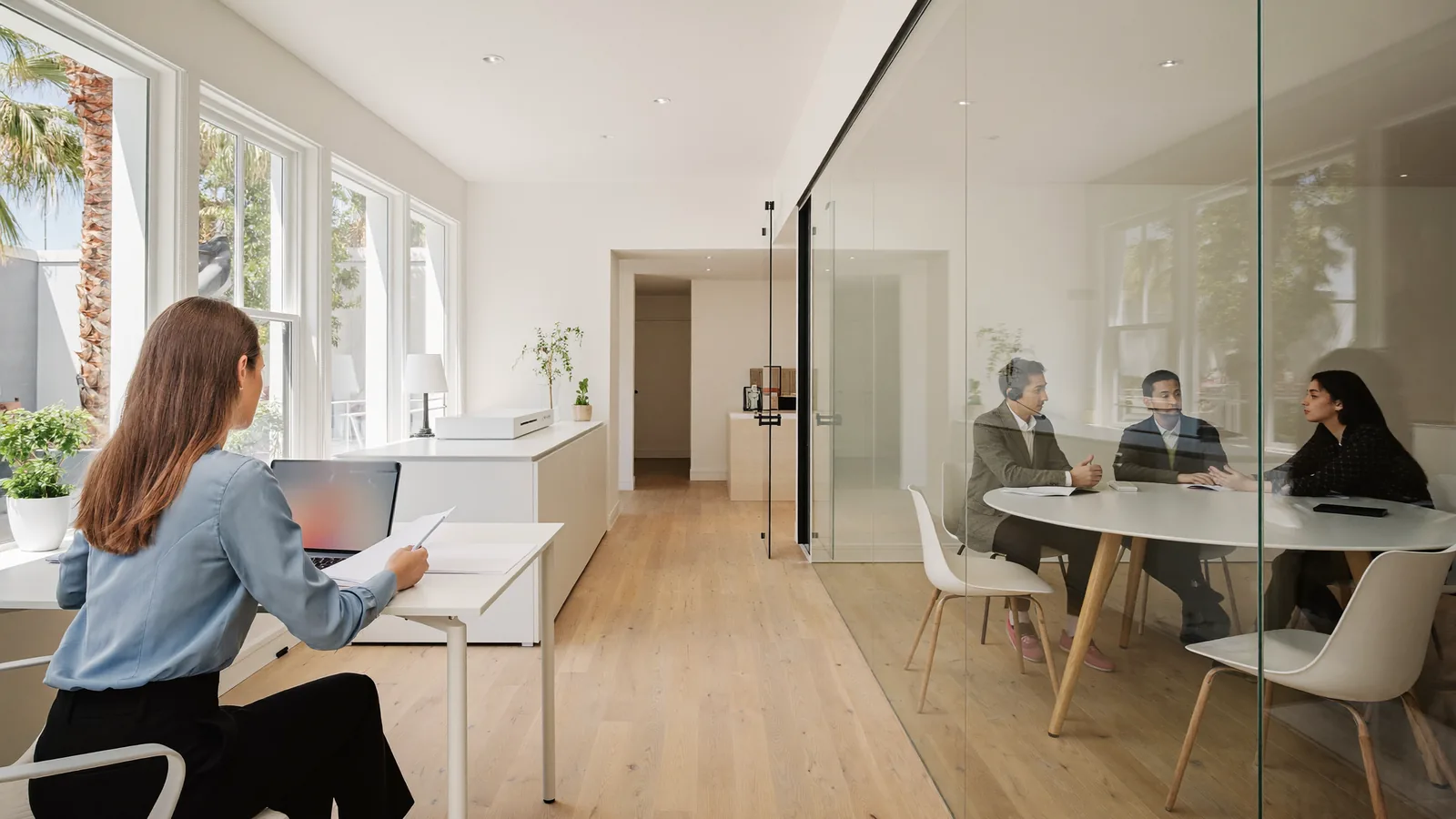 Translation vs interpretation shown as a translator reviewing documents and an interpreter assisting a meeting in a Miami office